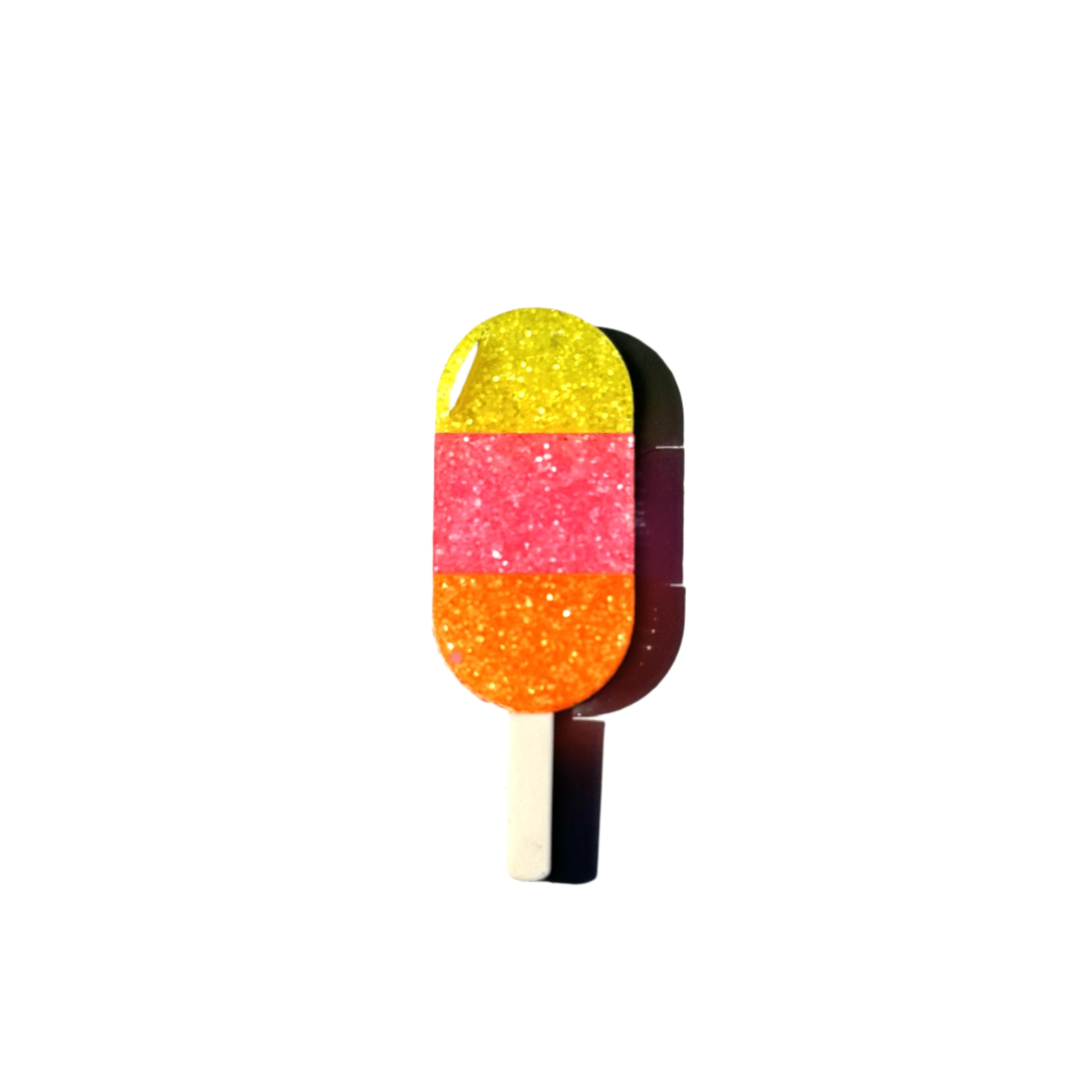 Glitter popsicle pin in yellow, pink, and orange stripes.