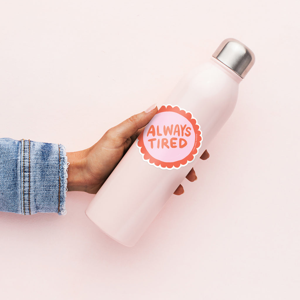Vinyl sticker that says “Always Tired” in bold red text on a pink and orange design – Funky Confetti