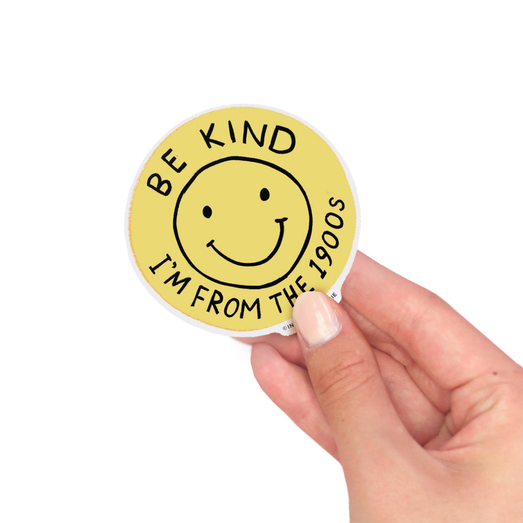 Round yellow vinyl sticker with smiley face that says “Be Kind I’m From the 1900s” – Funky Confetti