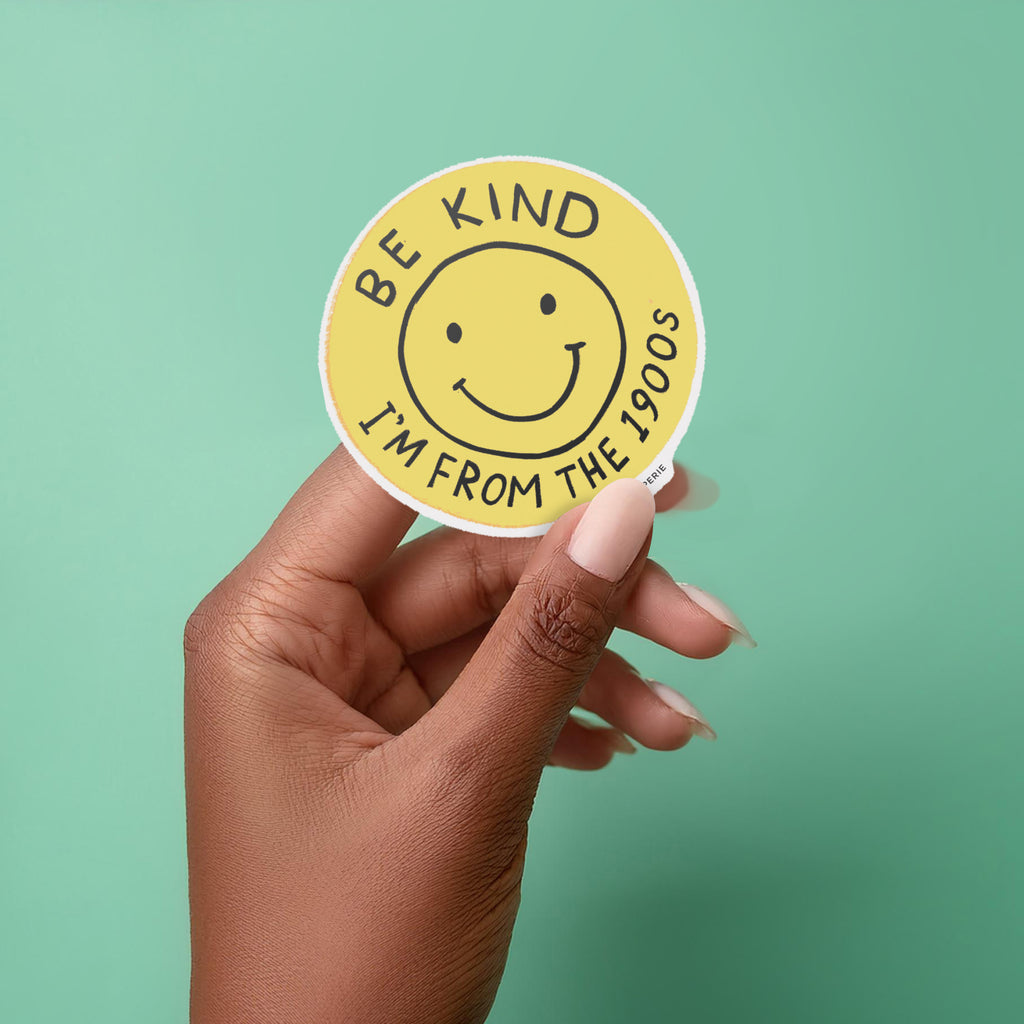 Round yellow vinyl sticker with smiley face that says “Be Kind I’m From the 1900s” – Funky Confetti