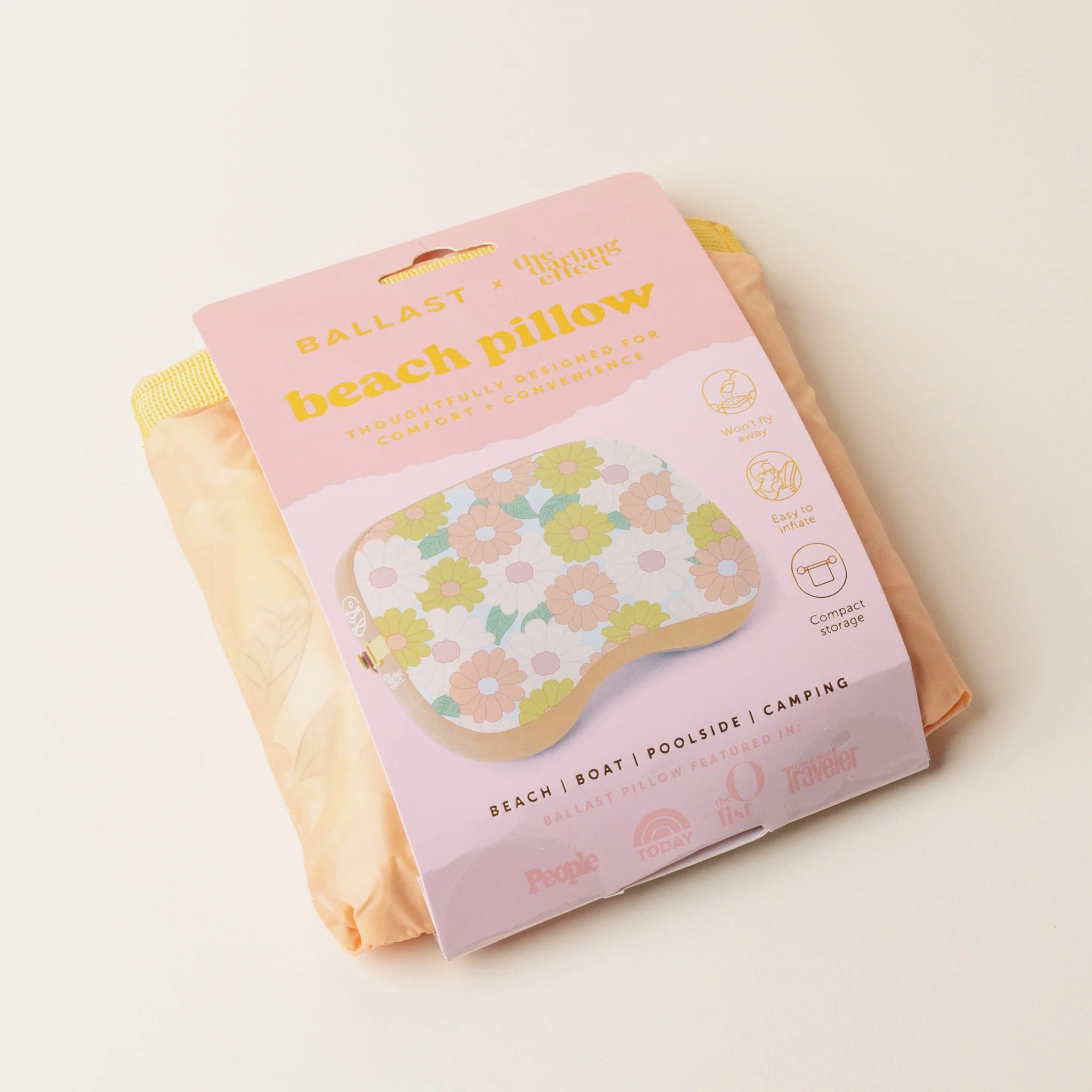 Peach daisy-patterned inflatable beach pillow with sand pocket for wind resistance from Funky Confetti