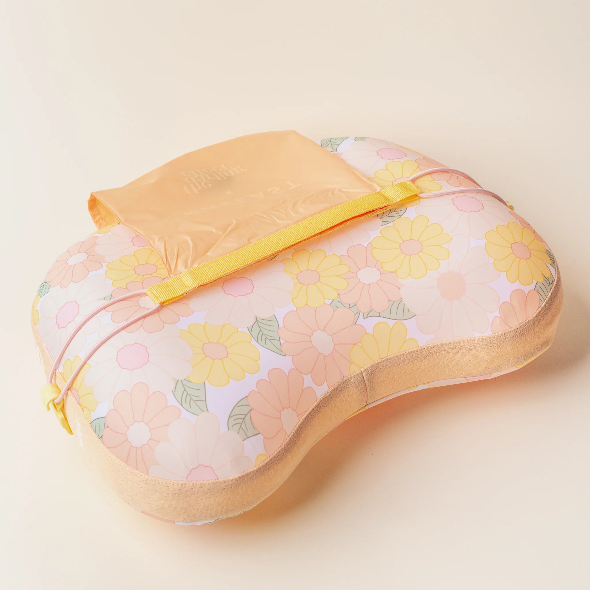 Peach daisy-patterned inflatable beach pillow with sand pocket for wind resistance from Funky Confetti