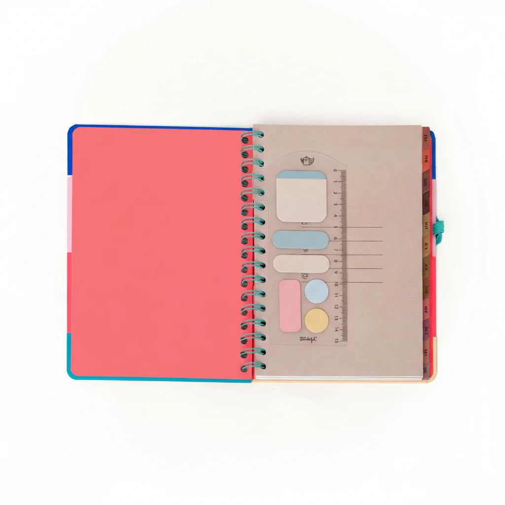 2026 weekly planner with colorful cover, teal elastic band, and erasable pen from Funky Confetti