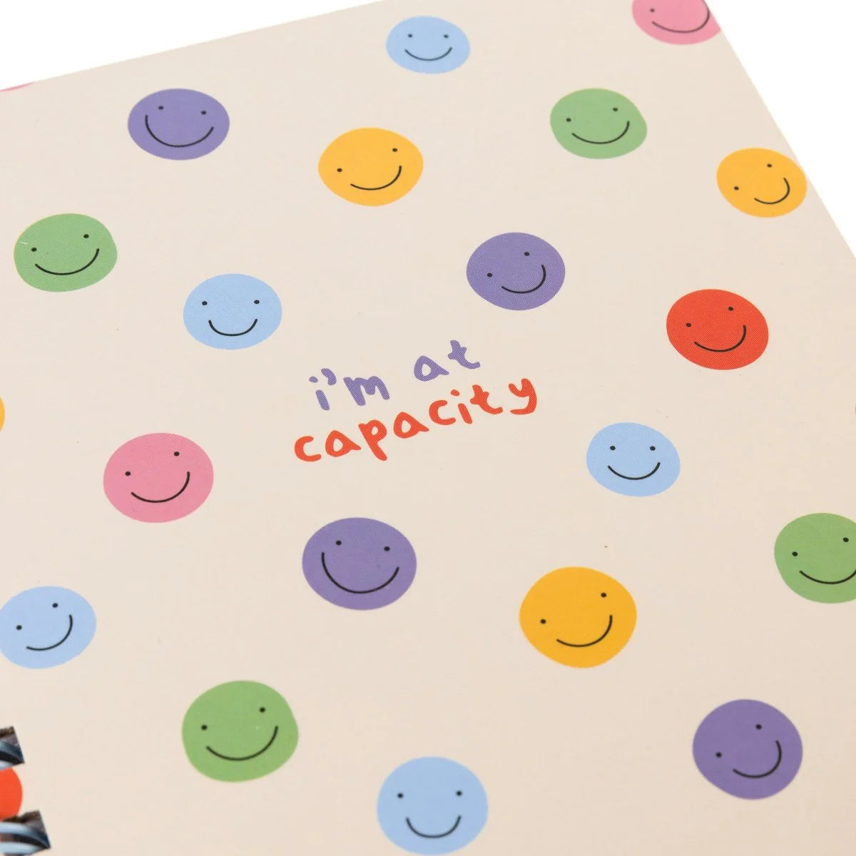 At Capacity spiral hardcover journal with colorful smiley face pattern and 160 lined pages by Funky Confetti