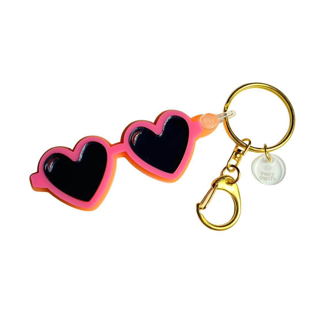Heart sunglasses acrylic keychain with pink and orange frames, black heart lenses, and gold hardware from Funky Confetti
