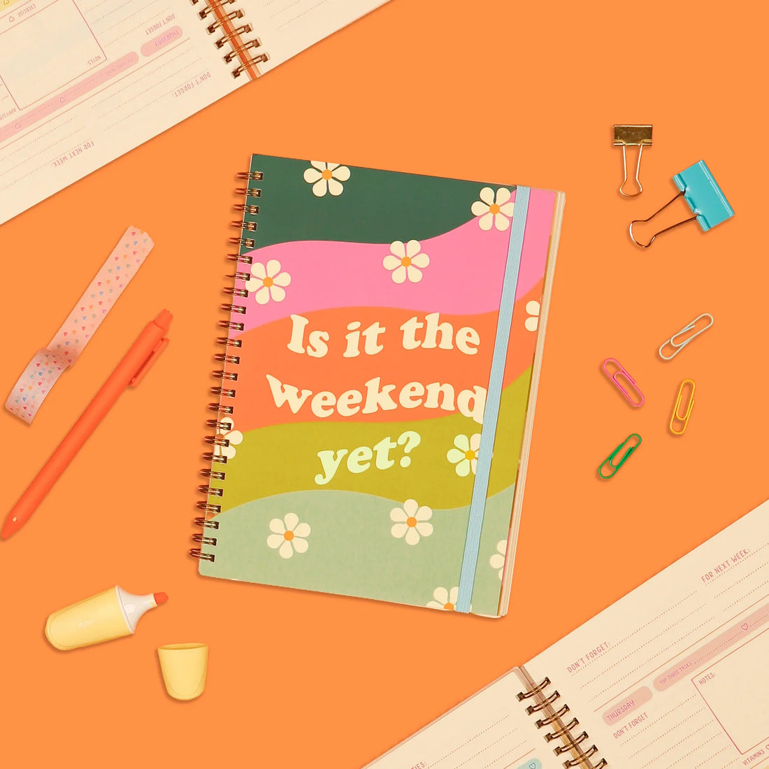 Is It The Weekend Yet? undated perpetual planner featuring a colorful rainbow cover, spiral binding, stickers, and flexible weekly and monthly planning layouts by Funky Confetti.