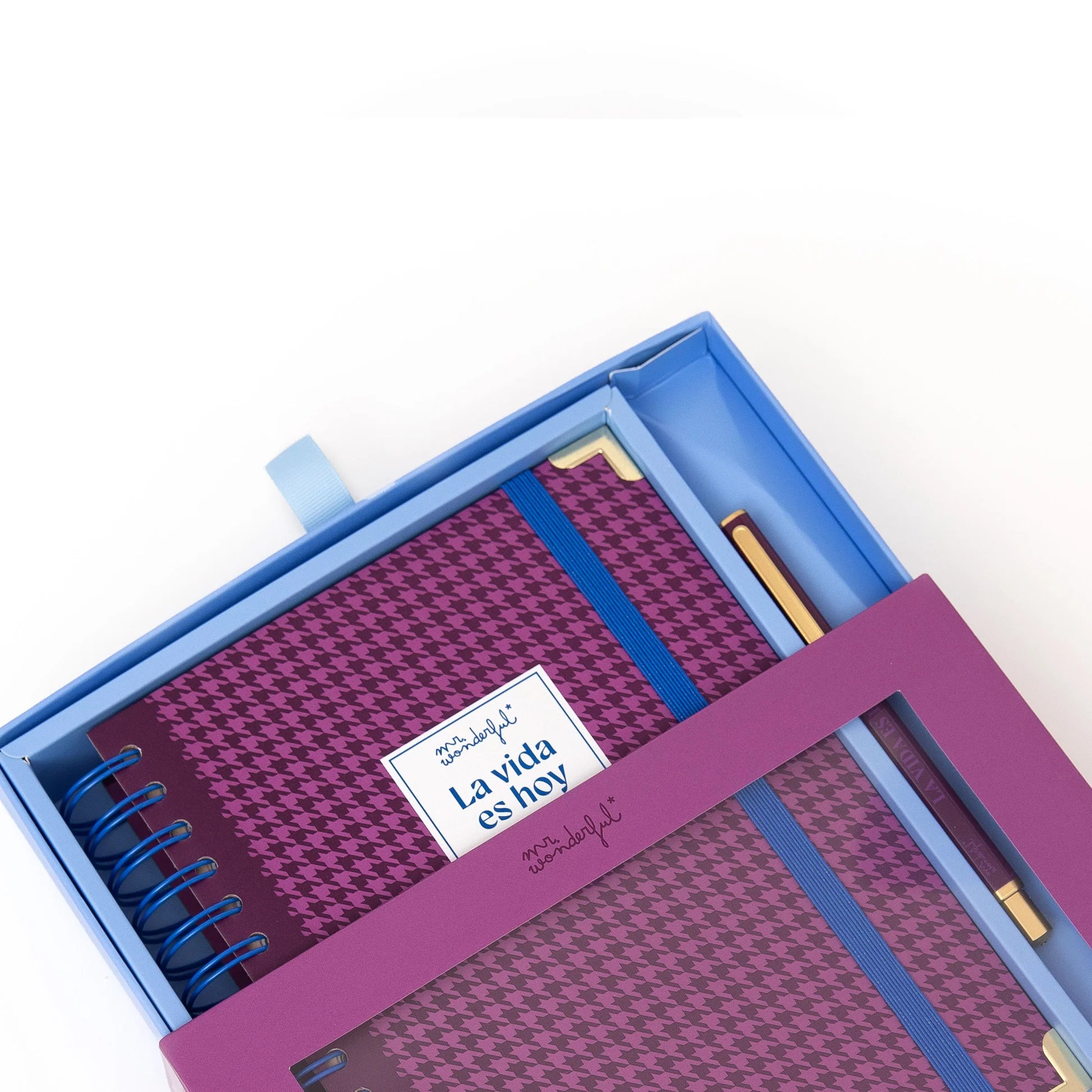 La Vida Es Hoy 2026 daily planner with purple cover, blue elastic band, and matching pen from Funky Confetti