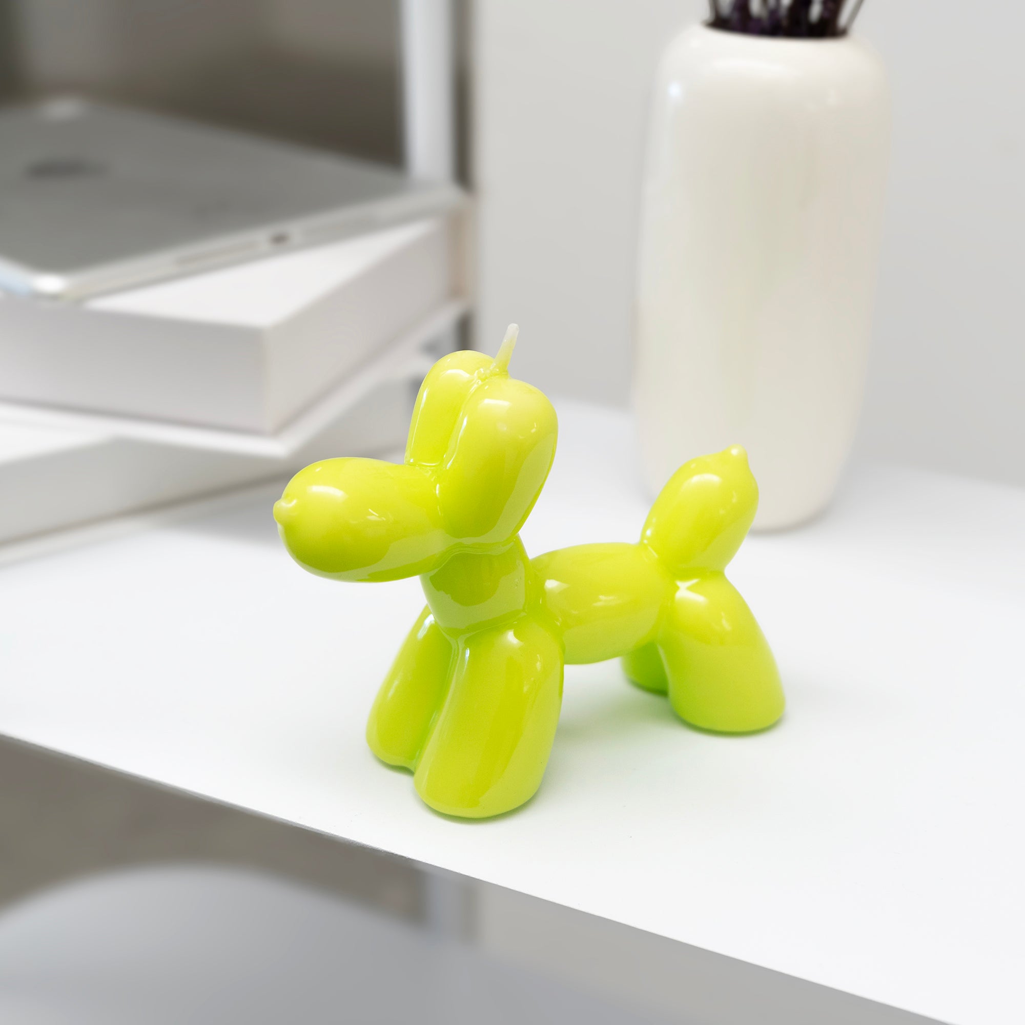 Glossy lime green balloon dog decorative candle for modern home décor and playful shelf styling by Funky Confetti.