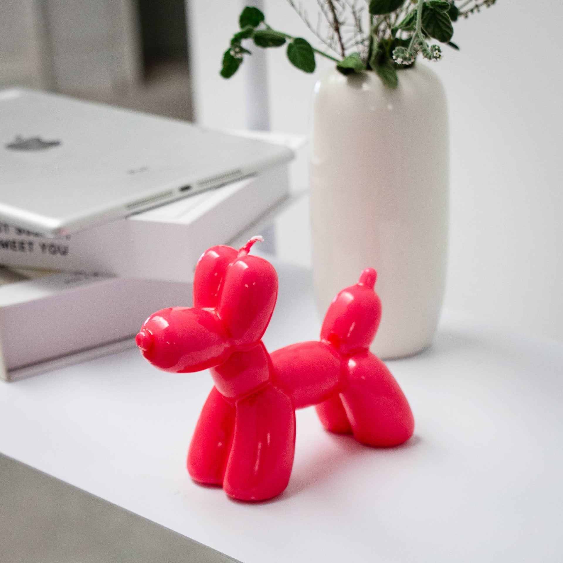 Glossy magenta balloon dog decorative candle for modern home décor and playful shelf styling by Funky Confetti.