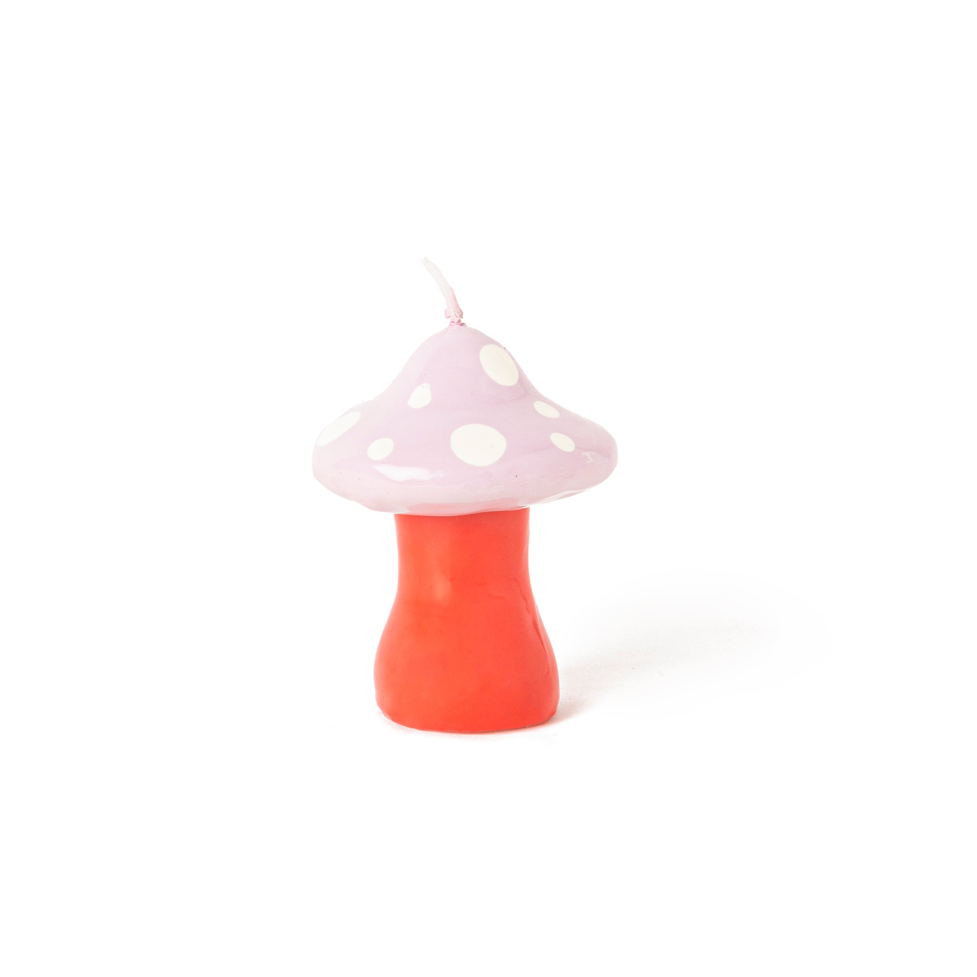 Small pink mushroom-shaped decorative candle with white polka dots and coral stem for whimsical home décor by Funky Confetti.