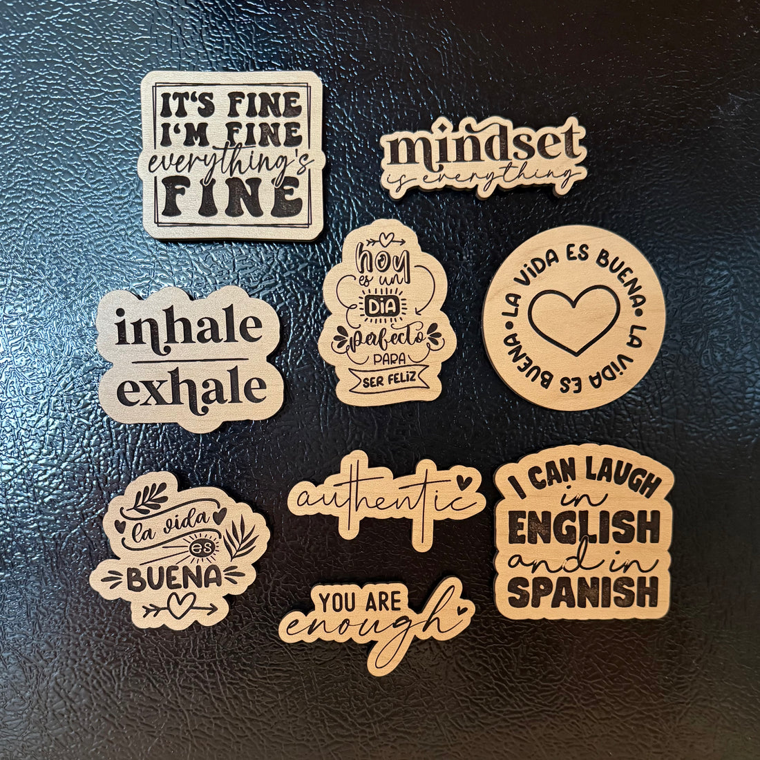 Set of motivational wooden stickers on a dark surface by Funky Confetti