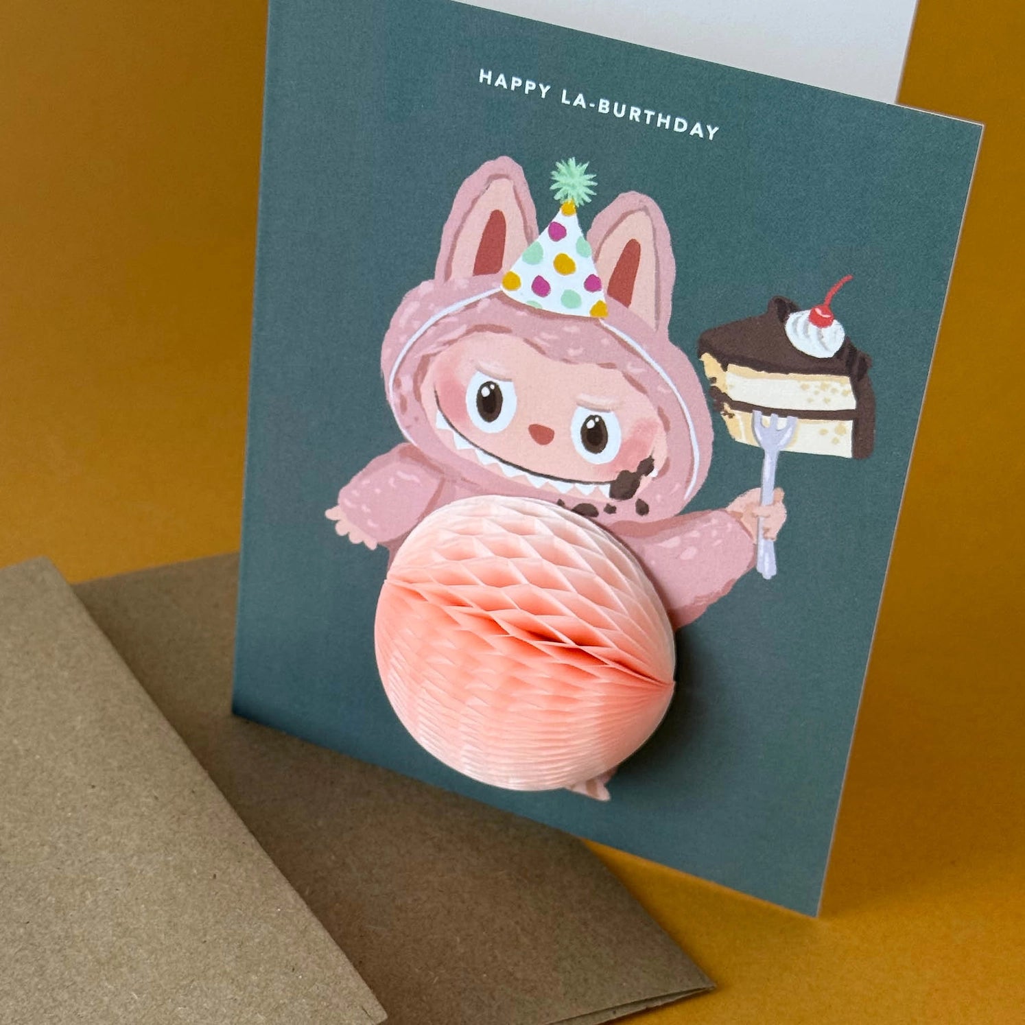 Birthday greeting card featuring cute Labubu monster in party hat holding cake with 3D honeycomb belly pop-up – Funky Confetti