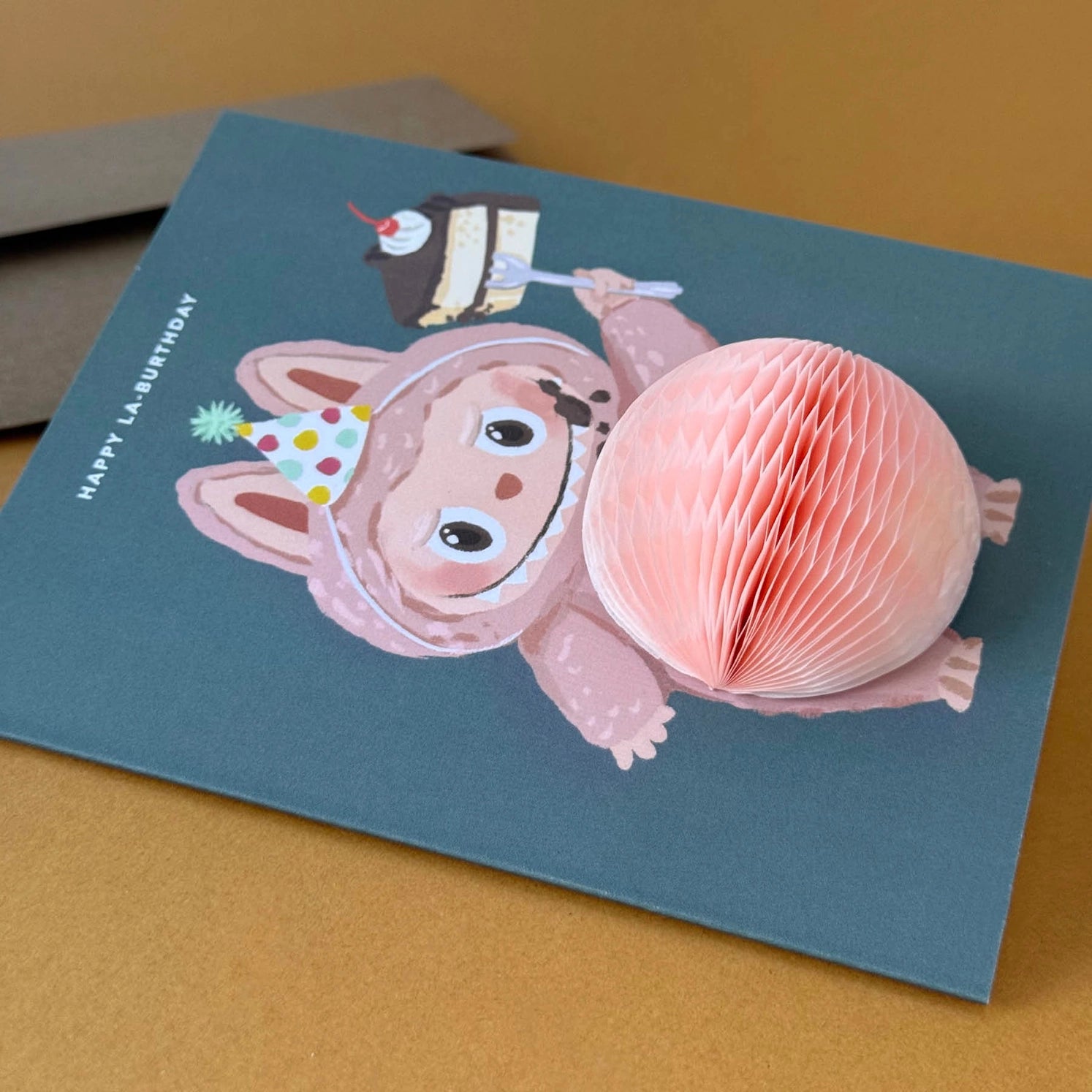 Birthday greeting card featuring cute Labubu monster in party hat holding cake with 3D honeycomb belly pop-up – Funky Confetti
