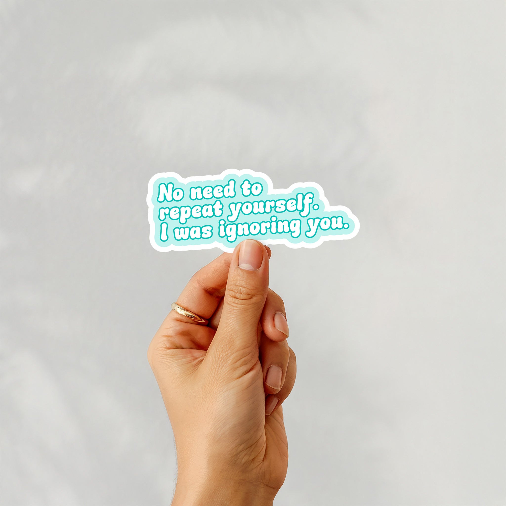 Vinyl sticker with phrase “No Need to Repeat Yourself. I Was Ignoring You.” in teal text with white border – Funky Confetti