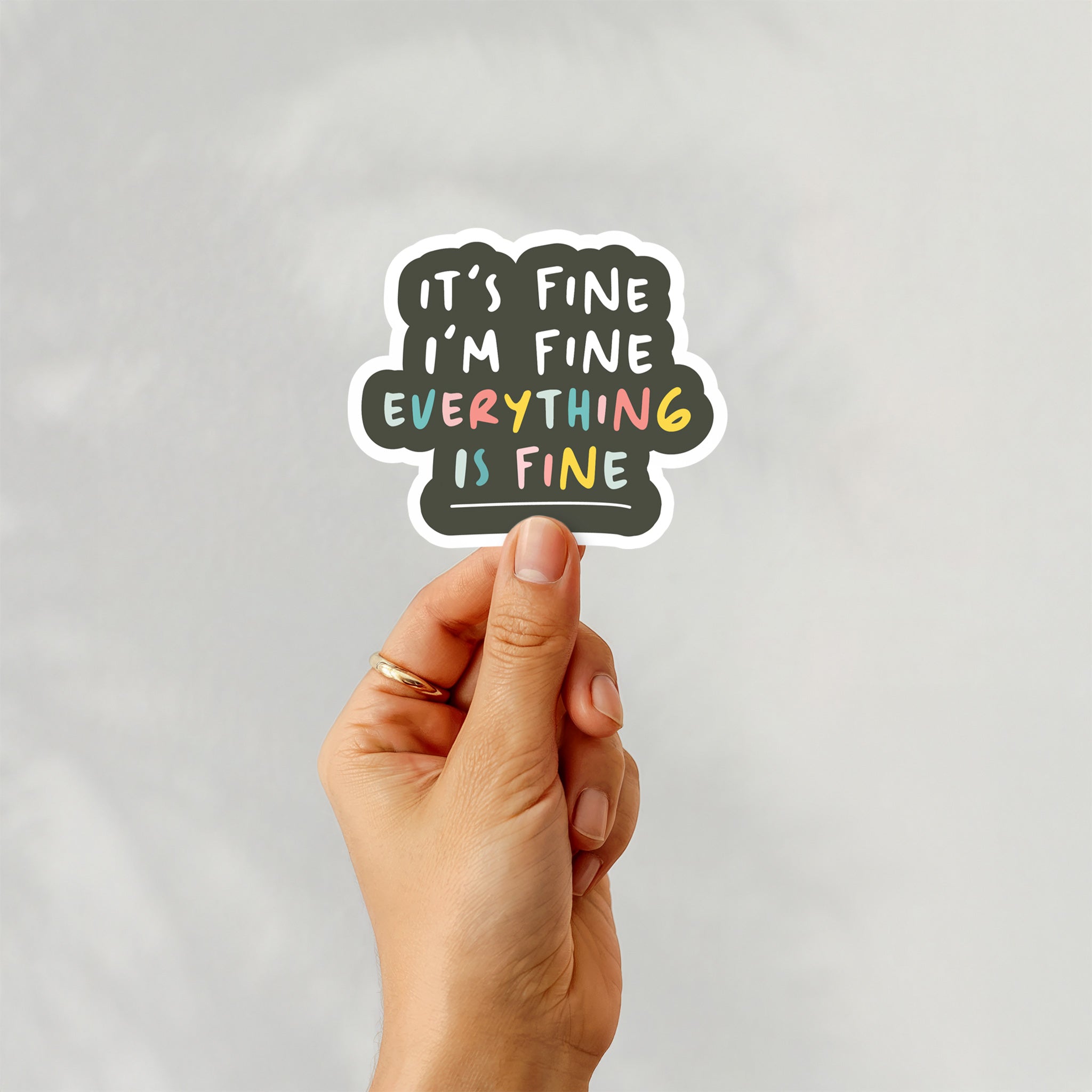 Vinyl sticker with text “It’s Fine, I’m Fine, Everything’s Fine” in colorful typography on black background – Funky Confetti