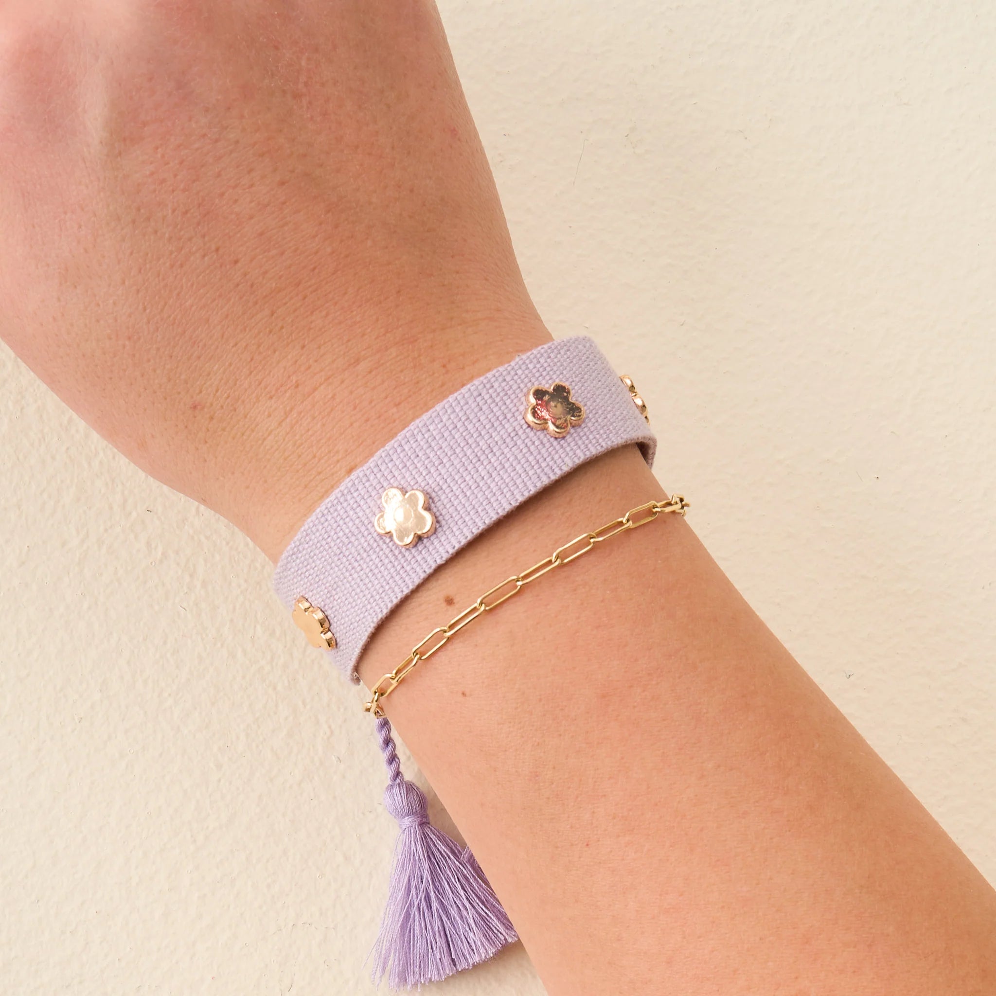 Lilac adjustable woven bracelet with gold flower charms and tassel ends from Funky Confetti
