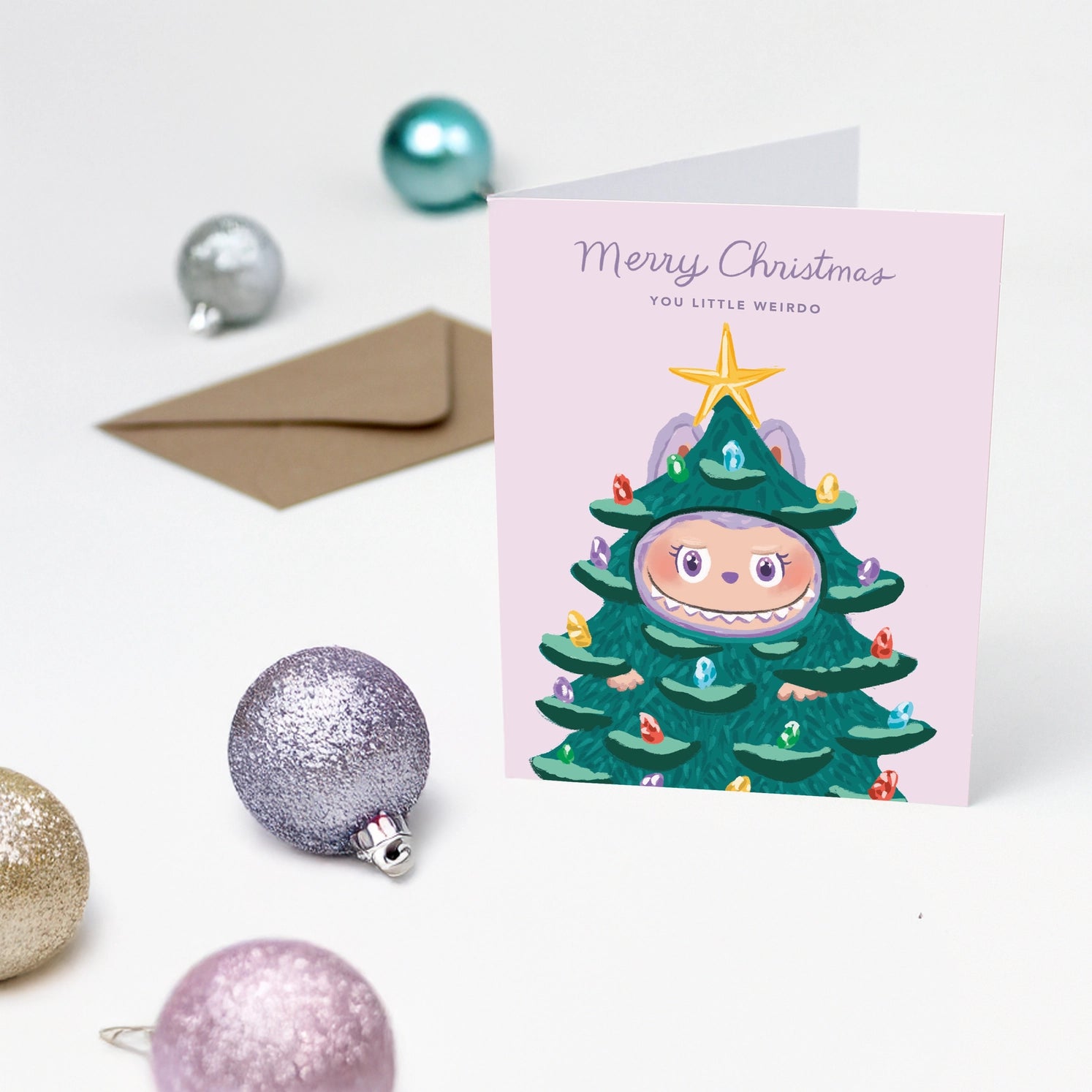 Cute Christmas card with monster dressed as Christmas tree and text “Merry Christmas You Little Weirdo” – Funky Confetti