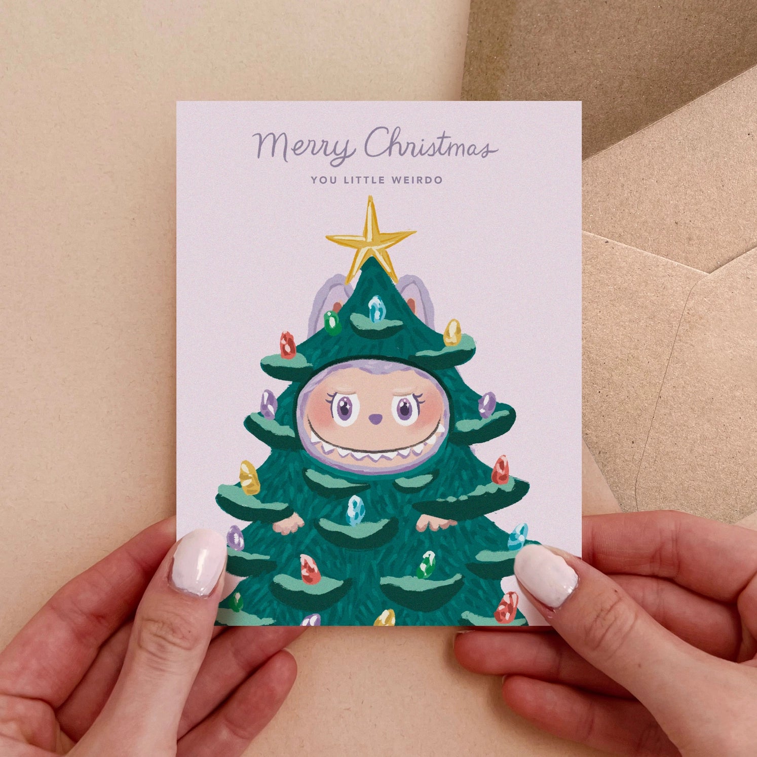 Cute Christmas card with monster dressed as Christmas tree and text “Merry Christmas You Little Weirdo” – Funky Confetti