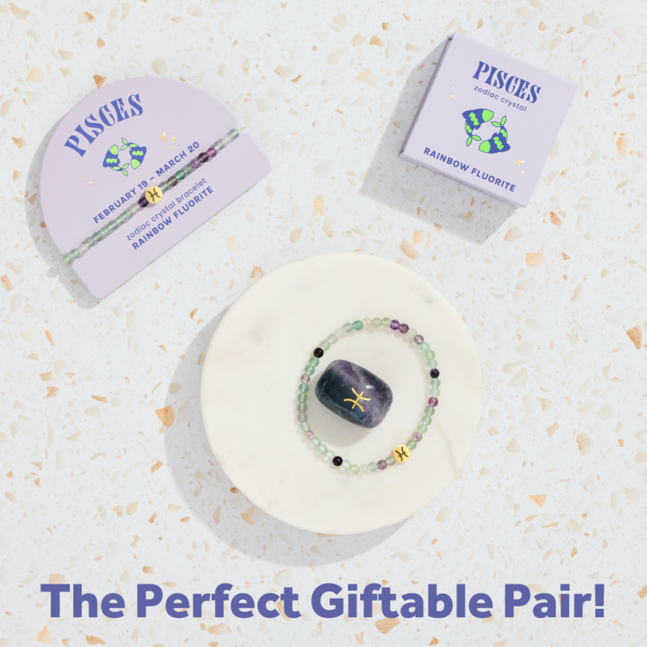 Zodiac-themed bracelet and crystal on a decorative background