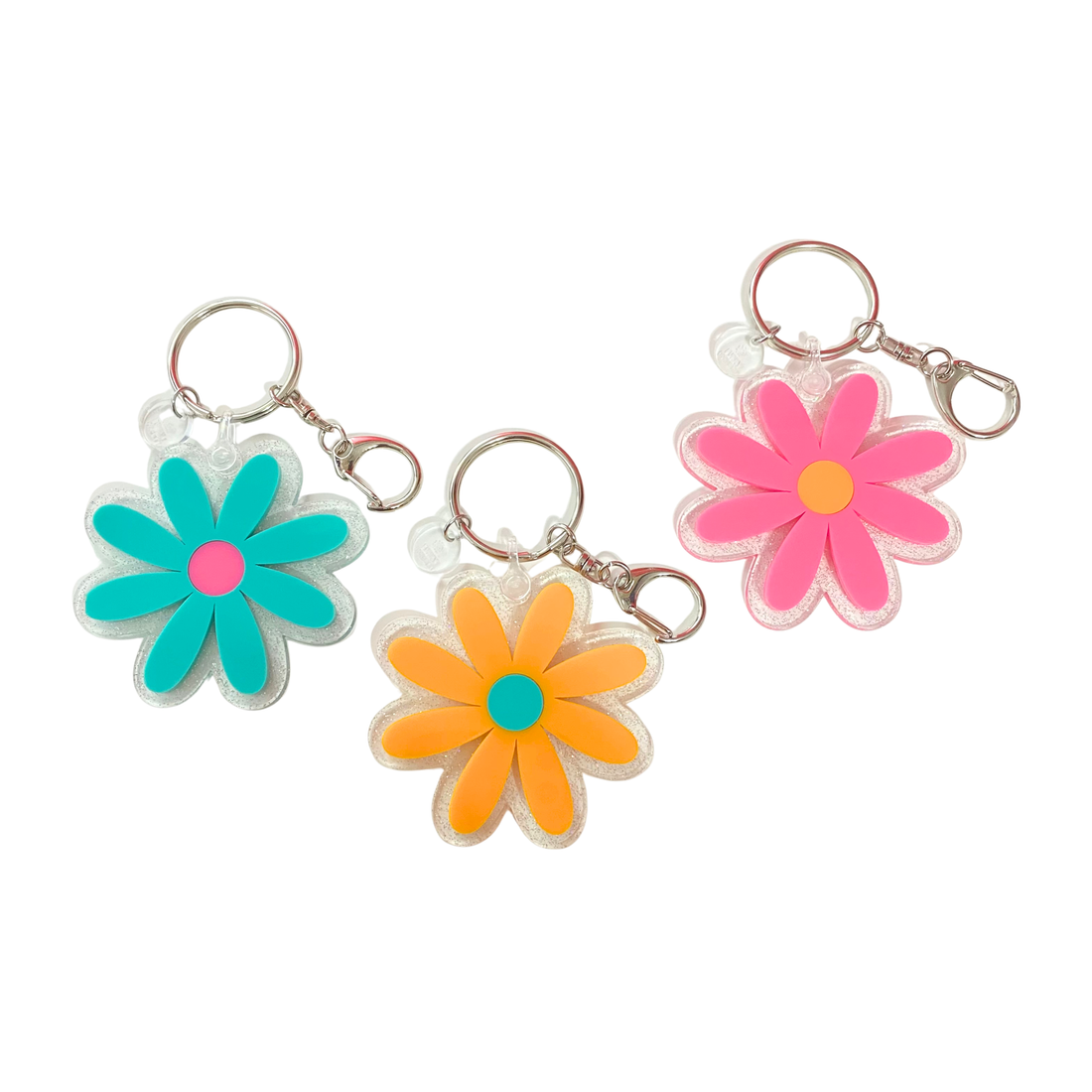 Colorful retro flower acrylic keychain with sparkly daisy charm available in pink, teal, and orange designs from Funky Confetti