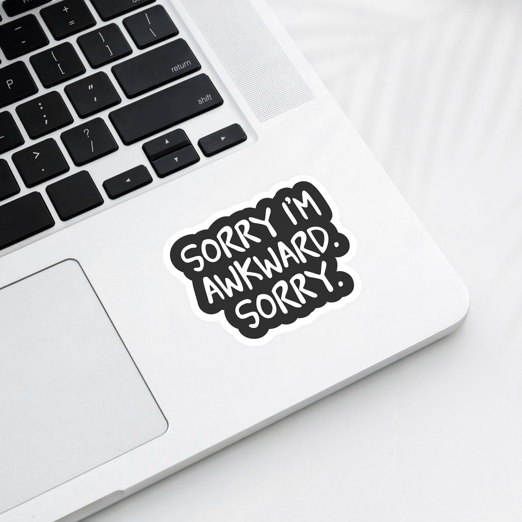 Vinyl sticker with phrase “Sorry I’m Awkward. Sorry.” in bold white text on black background – Funky Confetti