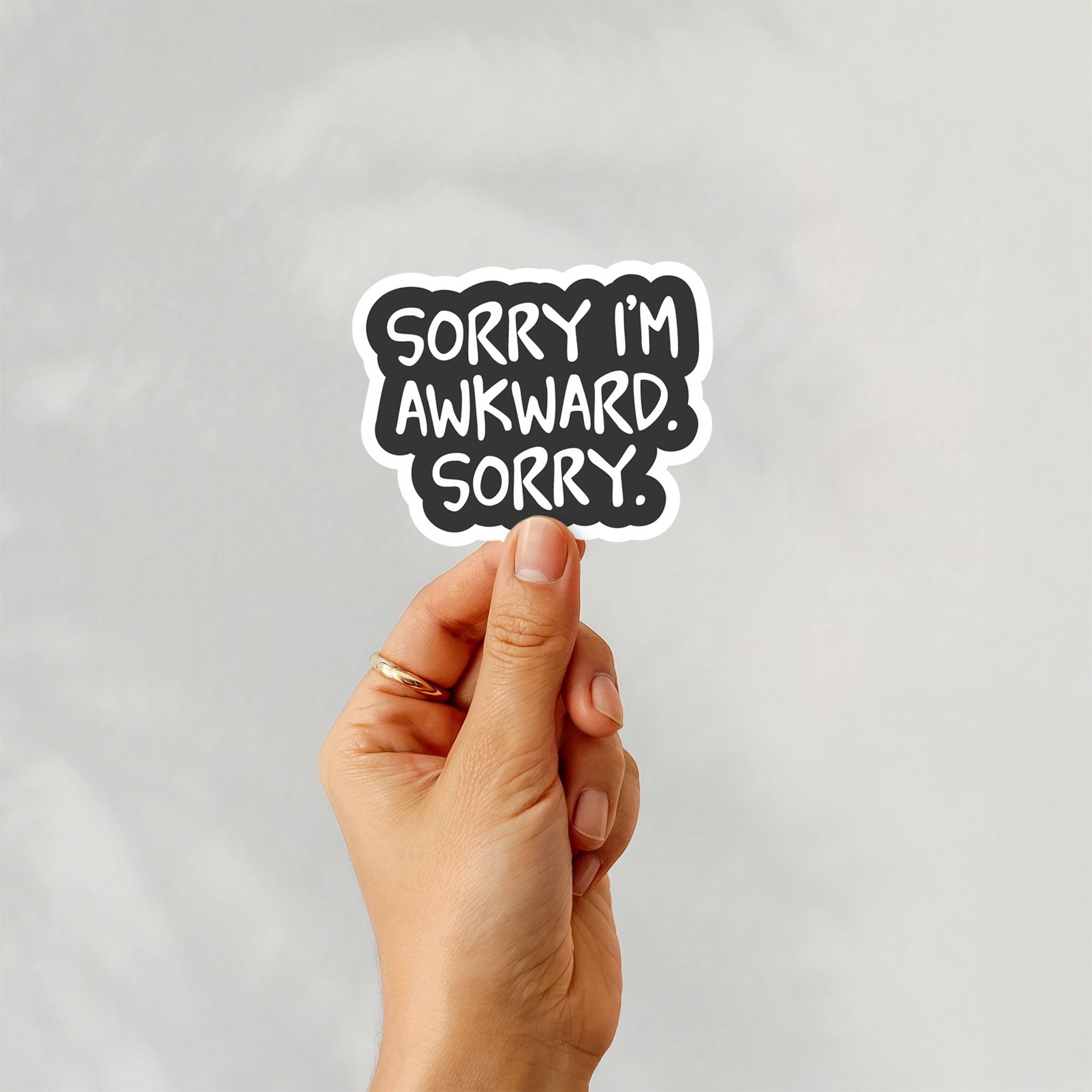 Vinyl sticker with phrase “Sorry I’m Awkward. Sorry.” in bold white text on black background – Funky Confetti