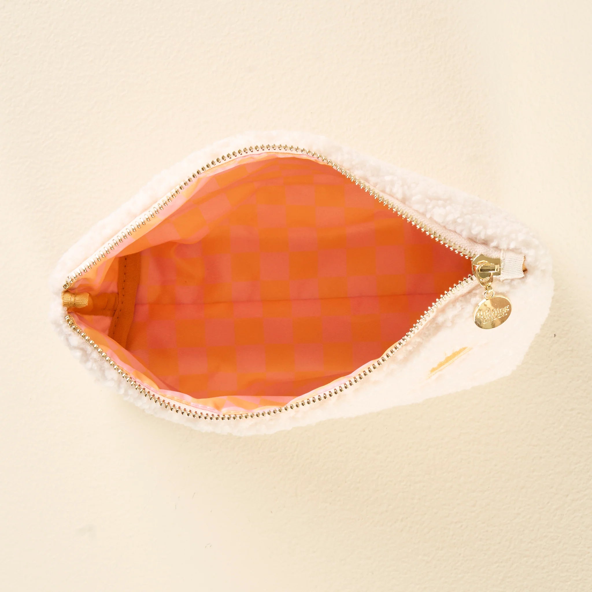 Cream sherpa teddy pouch with embroidered yellow sun pattern and gold zipper from Funky Confetti