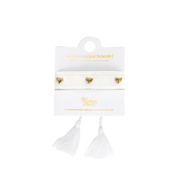 White adjustable woven bracelet with gold heart charms and tassel ends, stylish accessory from Funky Confetti