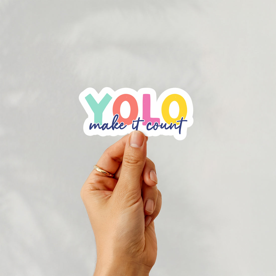 Colorful vinyl sticker with text “YOLO – Make It Count” in bold rainbow colors – Funky Confetti